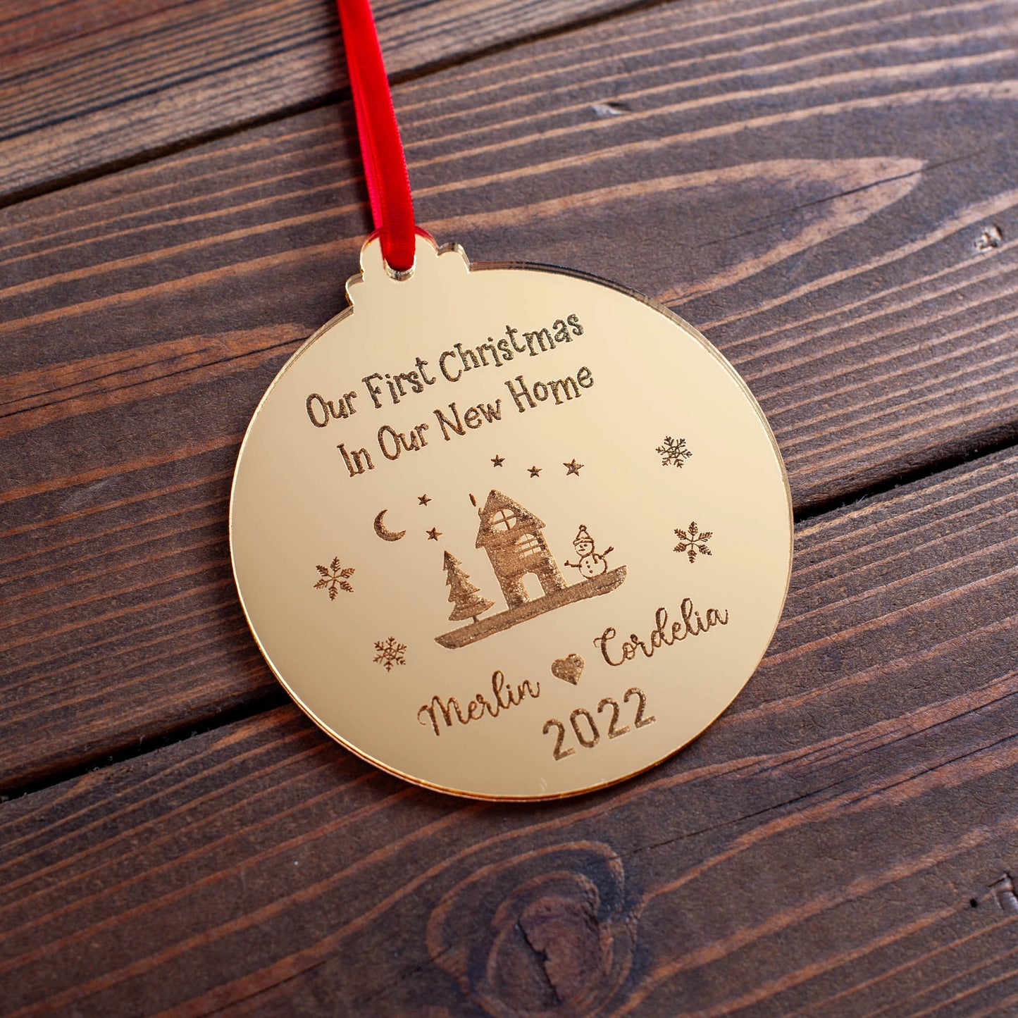 Personalised new house ornament hanging on table