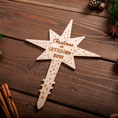 Handmade wooden star topper engraved with festive message