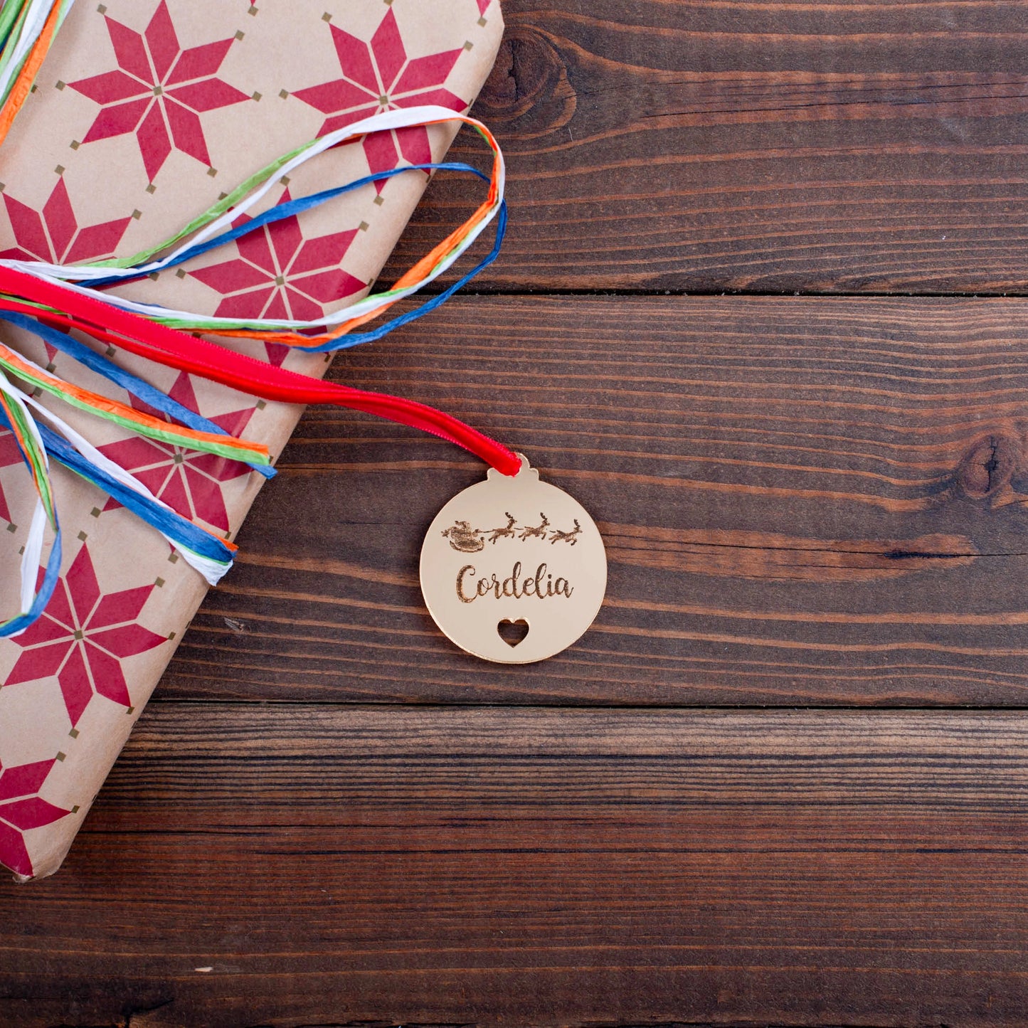 Engraved Christmas bauble tag with name, heart cut-out, and Santa design
