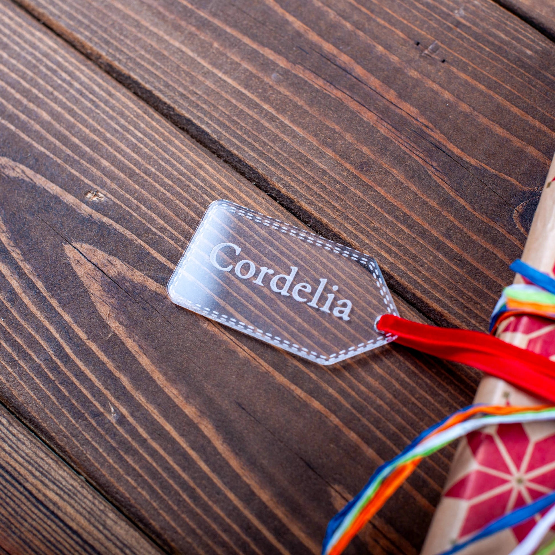 Engraved clear acrylic Christmas tag on wrapped present