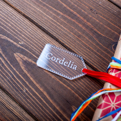 Engraved clear acrylic Christmas tag on wrapped present