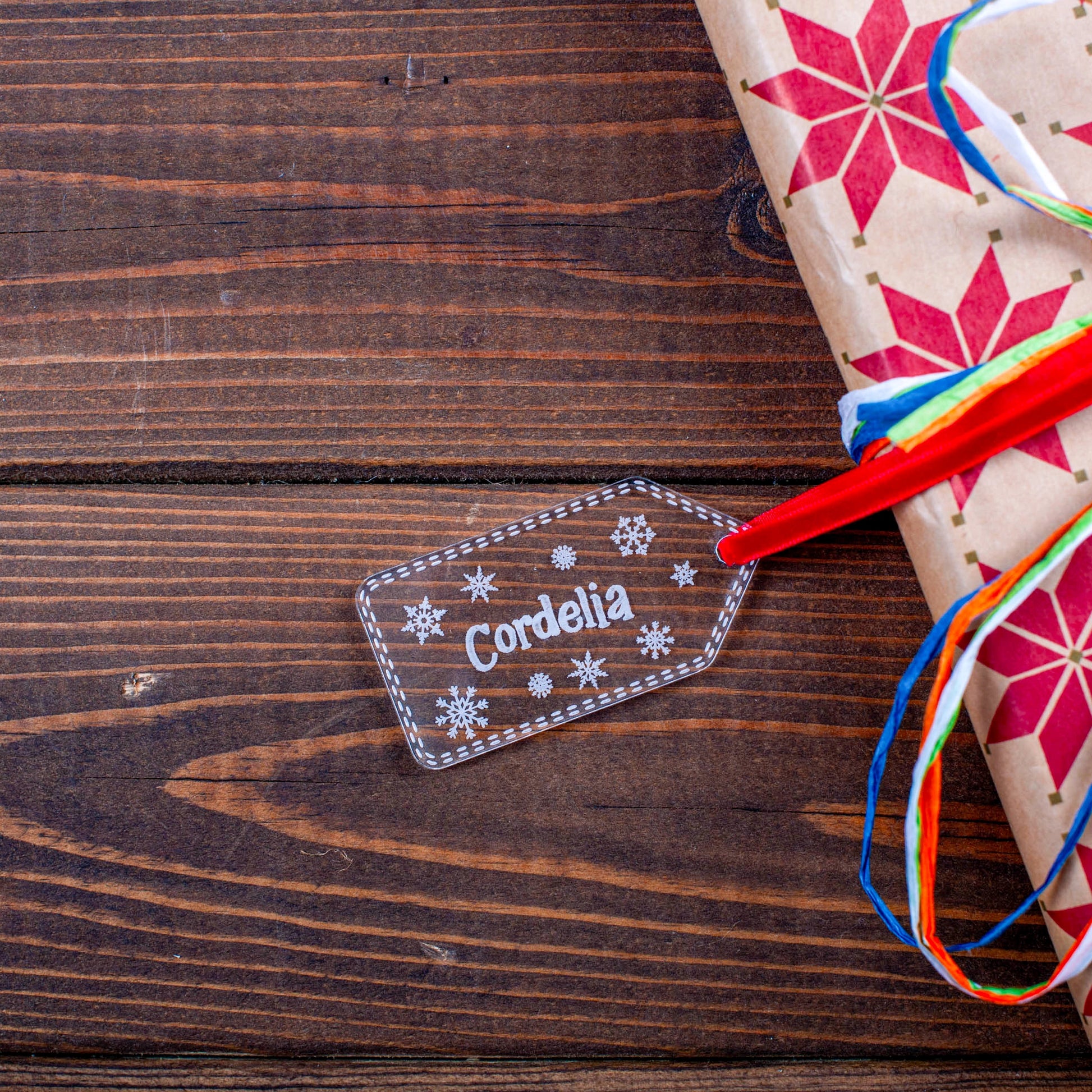 Personalised clear acrylic stocking name tag on wrapped present