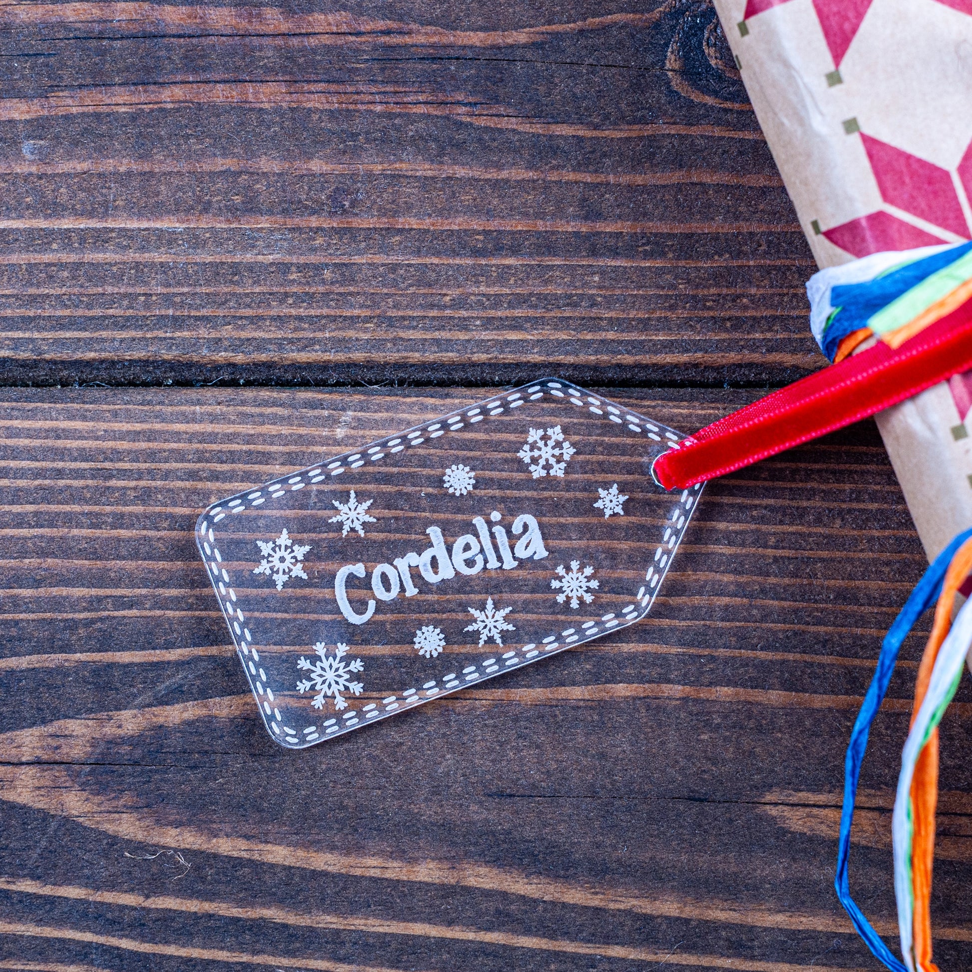 Clear acrylic Christmas gift tag engraved with snowflake and name