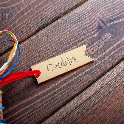 Close-up of engraved gold acrylic Christmas gift tag