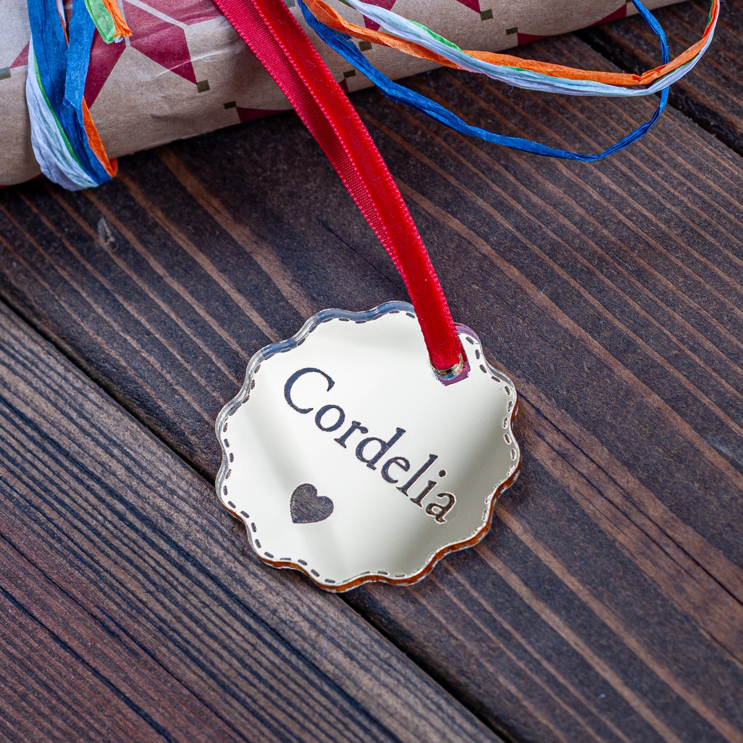 Gold mirror bauble style Christmas gift tag engraved with name