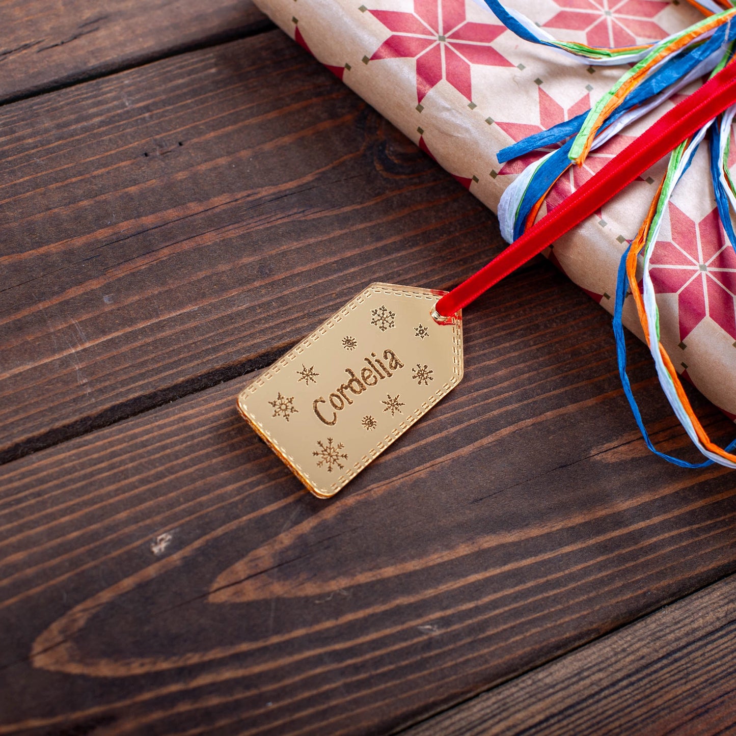 Engraved acrylic snowflake name tag for festive wrapping