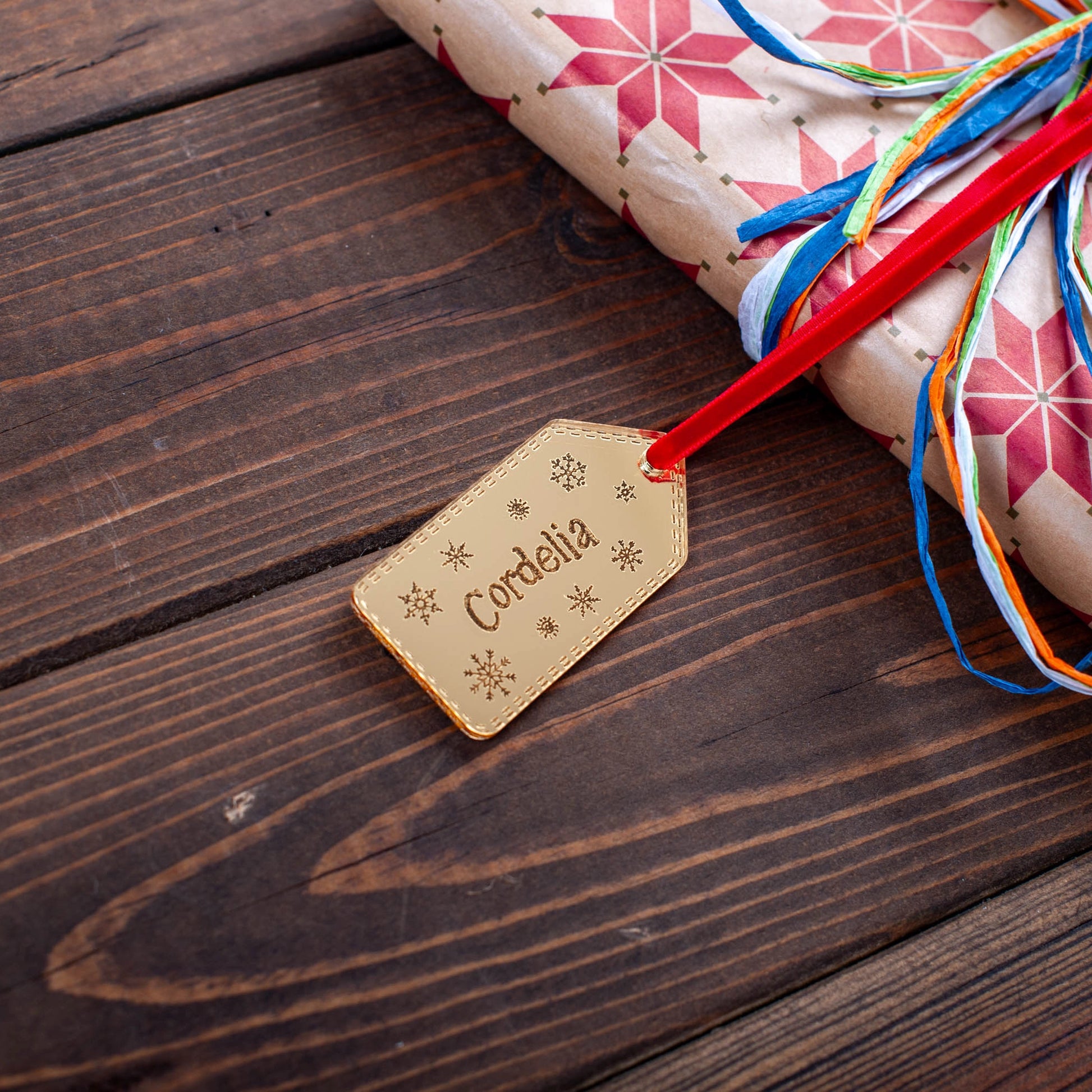 Engraved acrylic snowflake name tag for festive wrapping