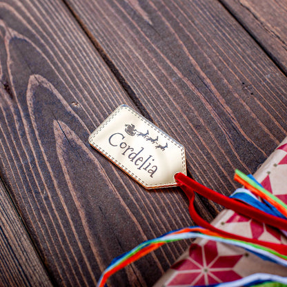 Engraved Santa and sleigh design on gold mirror tag