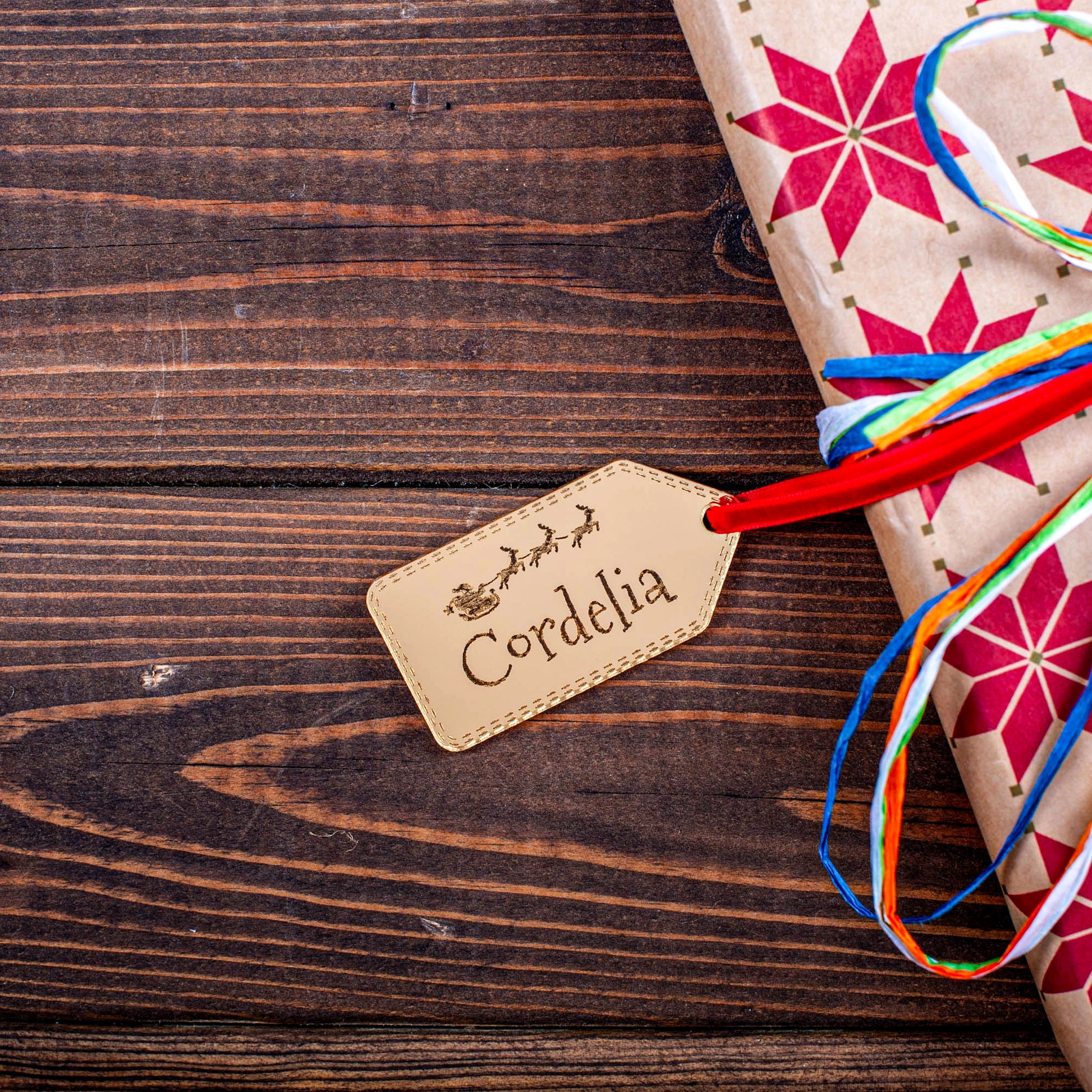 Luxury gold mirror acrylic Christmas tag reflecting fairy lights