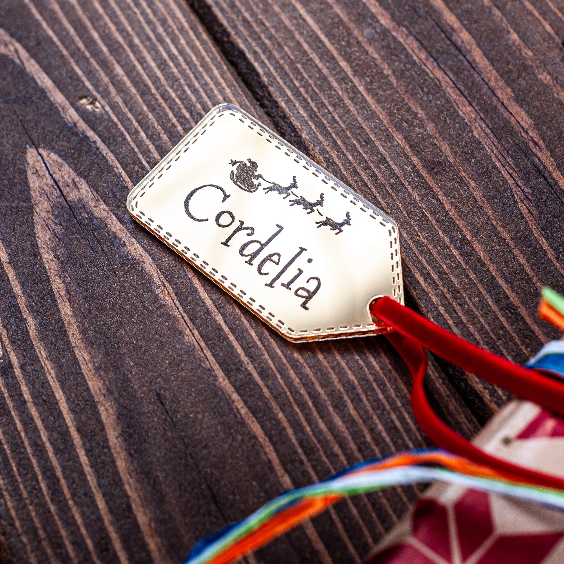 Gold mirror Christmas gift tag engraved with Santa and sleigh