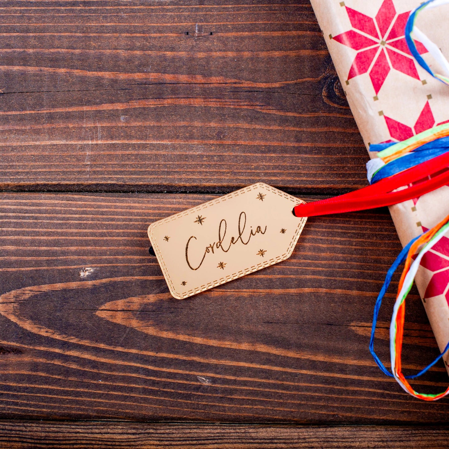 Luxury gold mirror tag reflecting Christmas lights