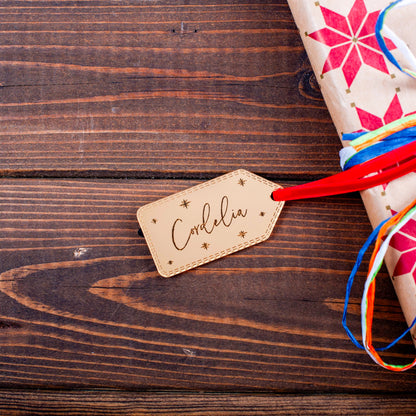 Luxury gold mirror tag reflecting Christmas lights