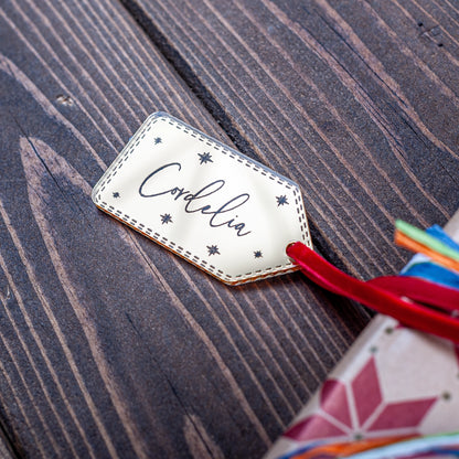 Gold mirror Christmas gift tag engraved with stars and name