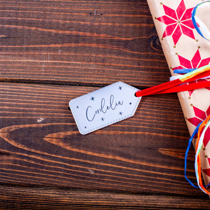 Reflective silver mirror Christmas tag on festive gift box