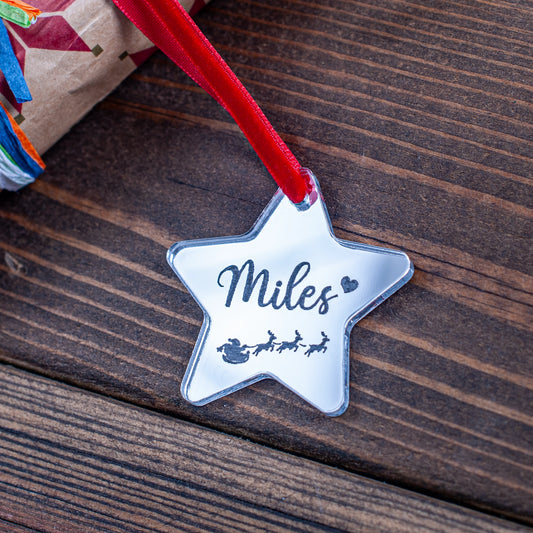 Silver mirror star-shaped Christmas gift tag engraved with Santa and sleigh