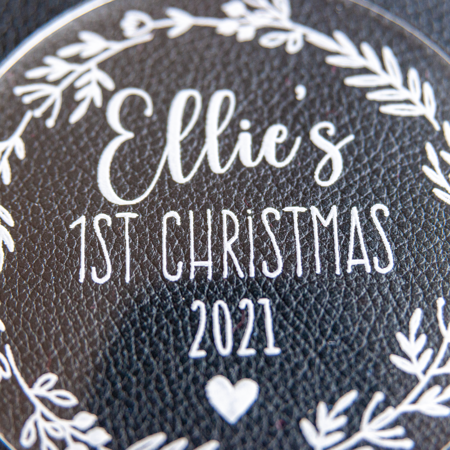 Engraving detail macro: baby’s name and star icons crisp on crystal-clear acrylic disc