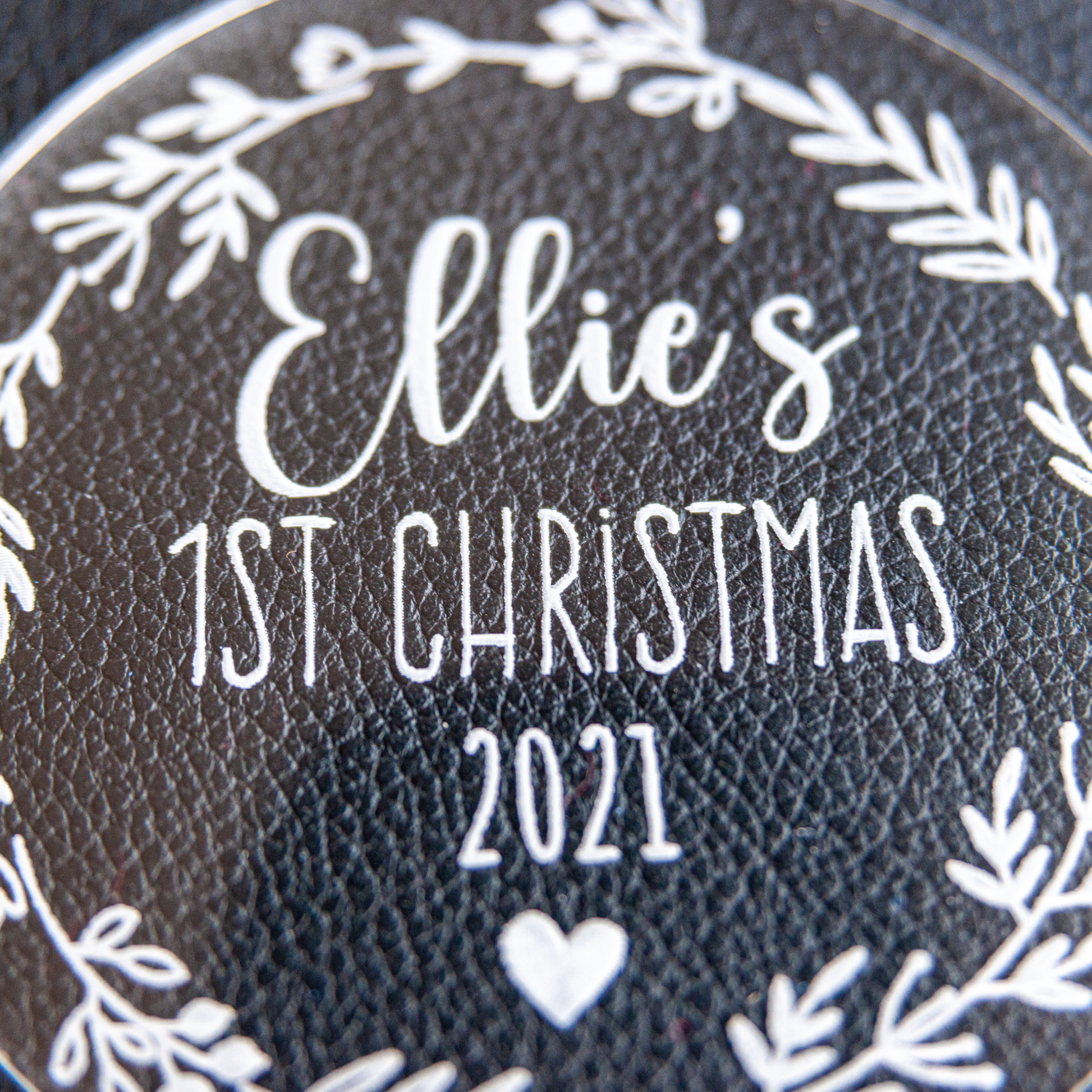 Engraving detail macro: baby’s name and star icons crisp on crystal-clear acrylic disc
