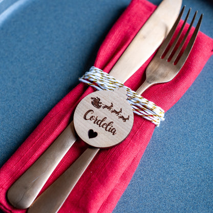 Rustic wooden Christmas name tag on festive dinner plate