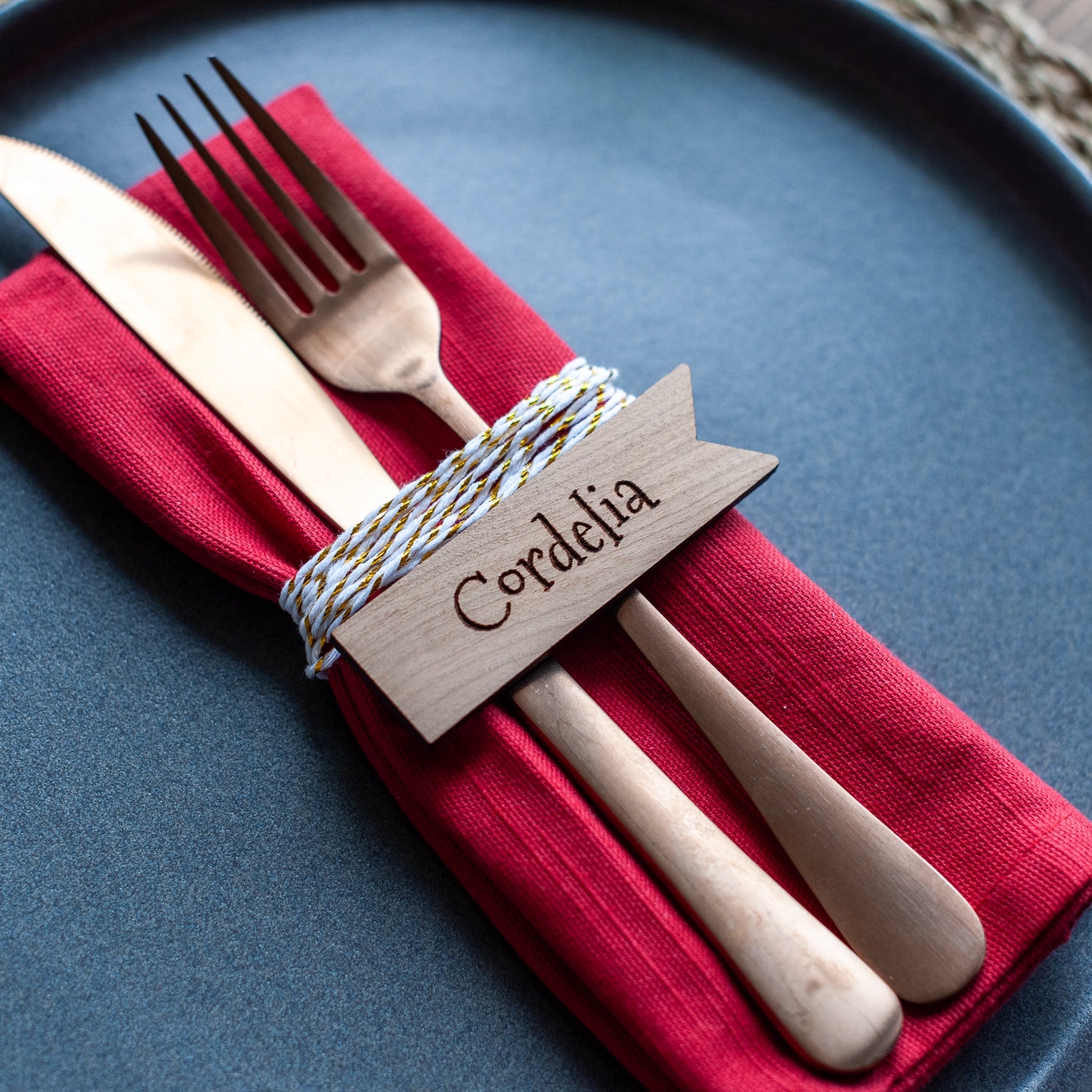Flat-lay of rectangular wooden place names on Christmas table