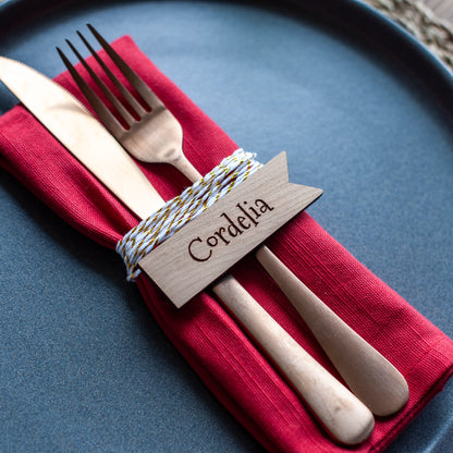 Flat-lay of rectangular wooden place names on Christmas table