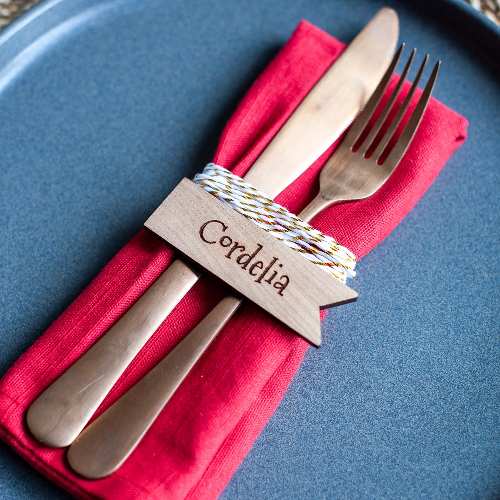 Rustic wooden name tag with engraved text for holiday dinner