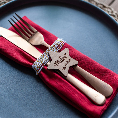 Engraved wooden Christmas name tag featuring Santa and sleigh