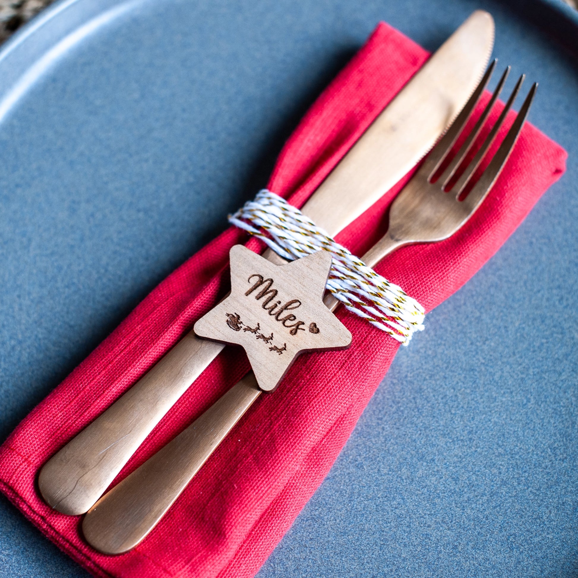 Rustic star-shaped wooden place card on festive dinner table
