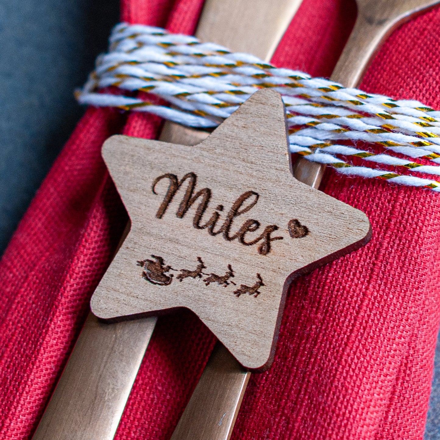Wooden star place name engraved with guest name and Santa sleigh design
