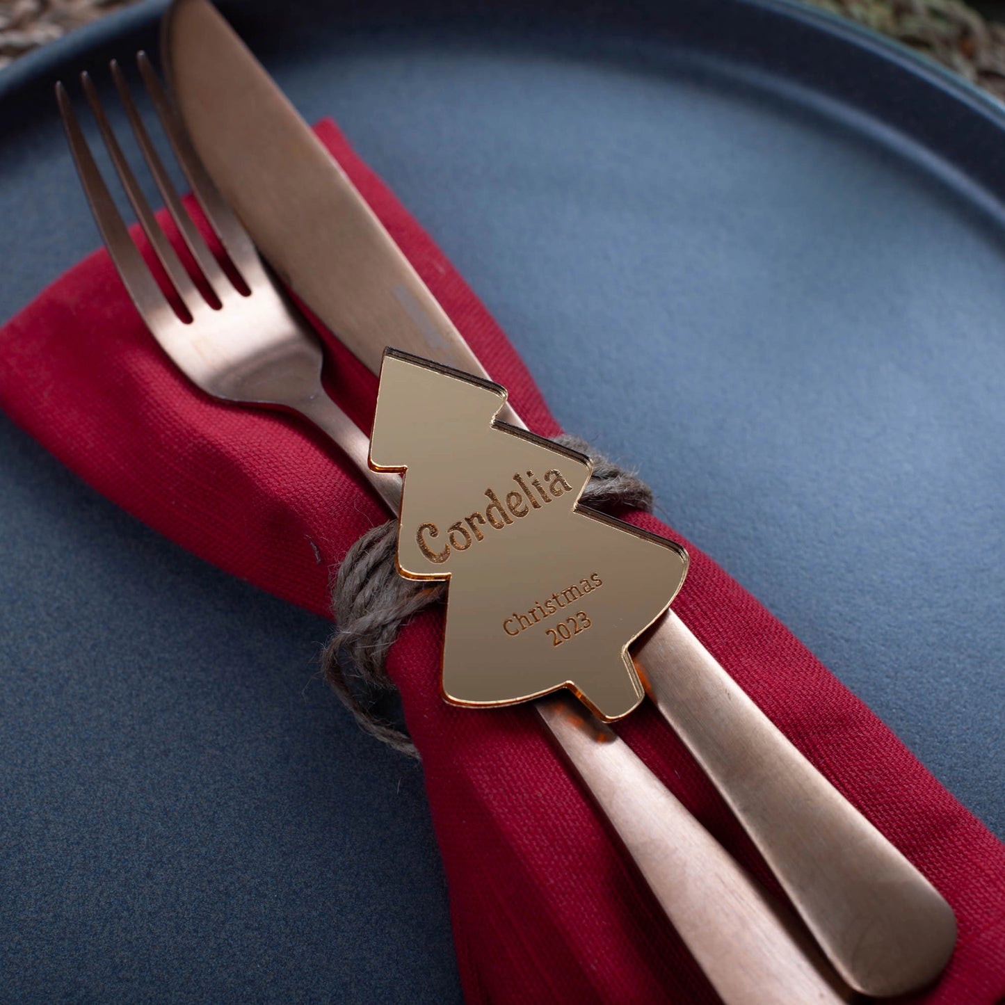 Custom gold mirror name place tag reflecting candlelight on festive table