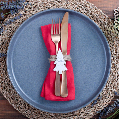 Engraved silver Christmas tree place card on festive dinner table