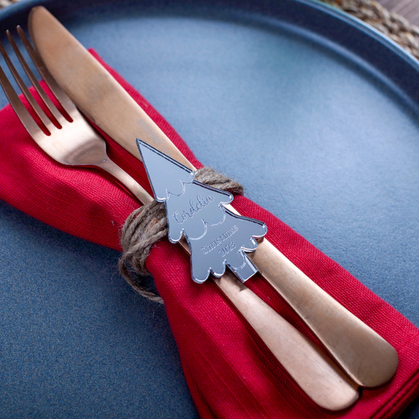 Reflective silver place setting card engraved with name and tree design