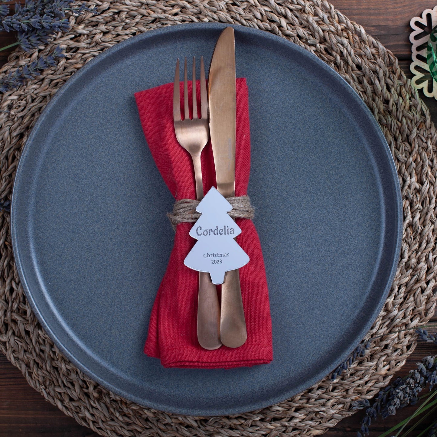 Silver mirror acrylic place card reflecting candlelight on Christmas table
