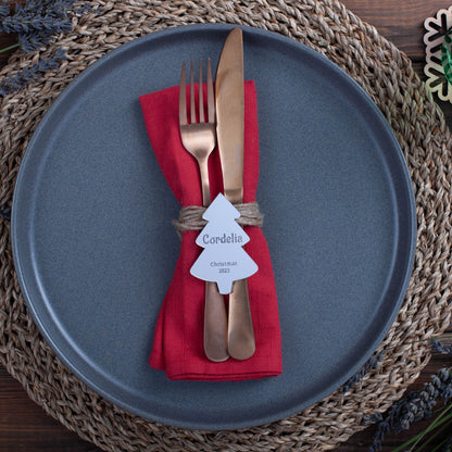Silver mirror acrylic place card reflecting candlelight on Christmas table