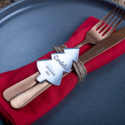 Elegant silver mirror name tag displayed on festive napkin and plate