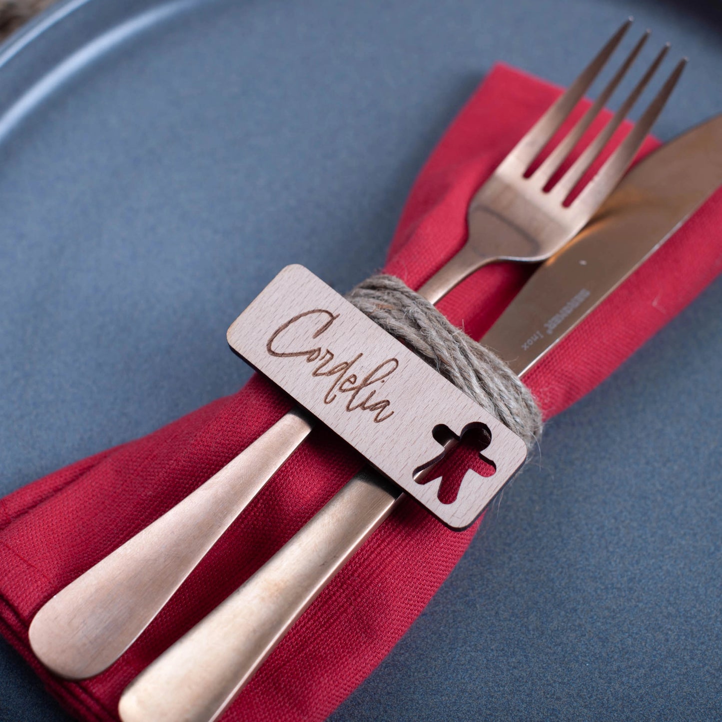 Rustic wooden place card engraved with name for festive dinner table gingerbread man cut-out