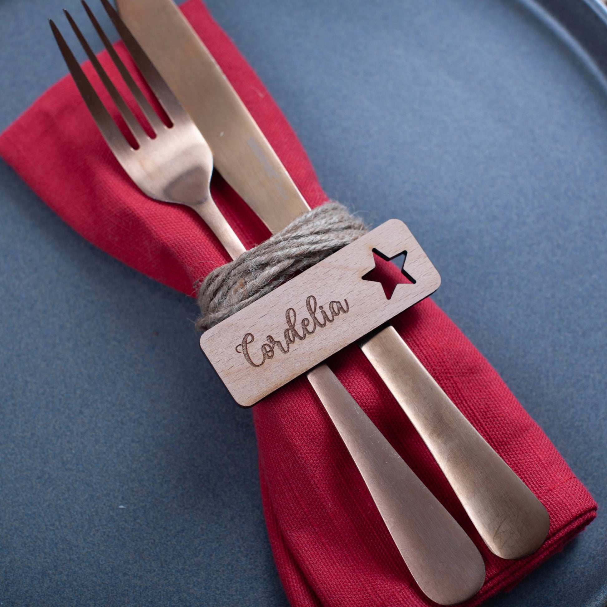 Festive wooden table name tag engraved with name and star cutouts