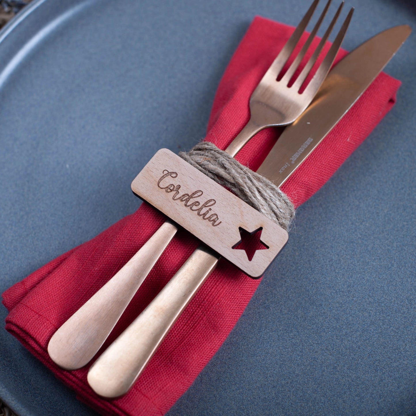 Handcrafted wooden Christmas decoration with engraved guest name and star cutout