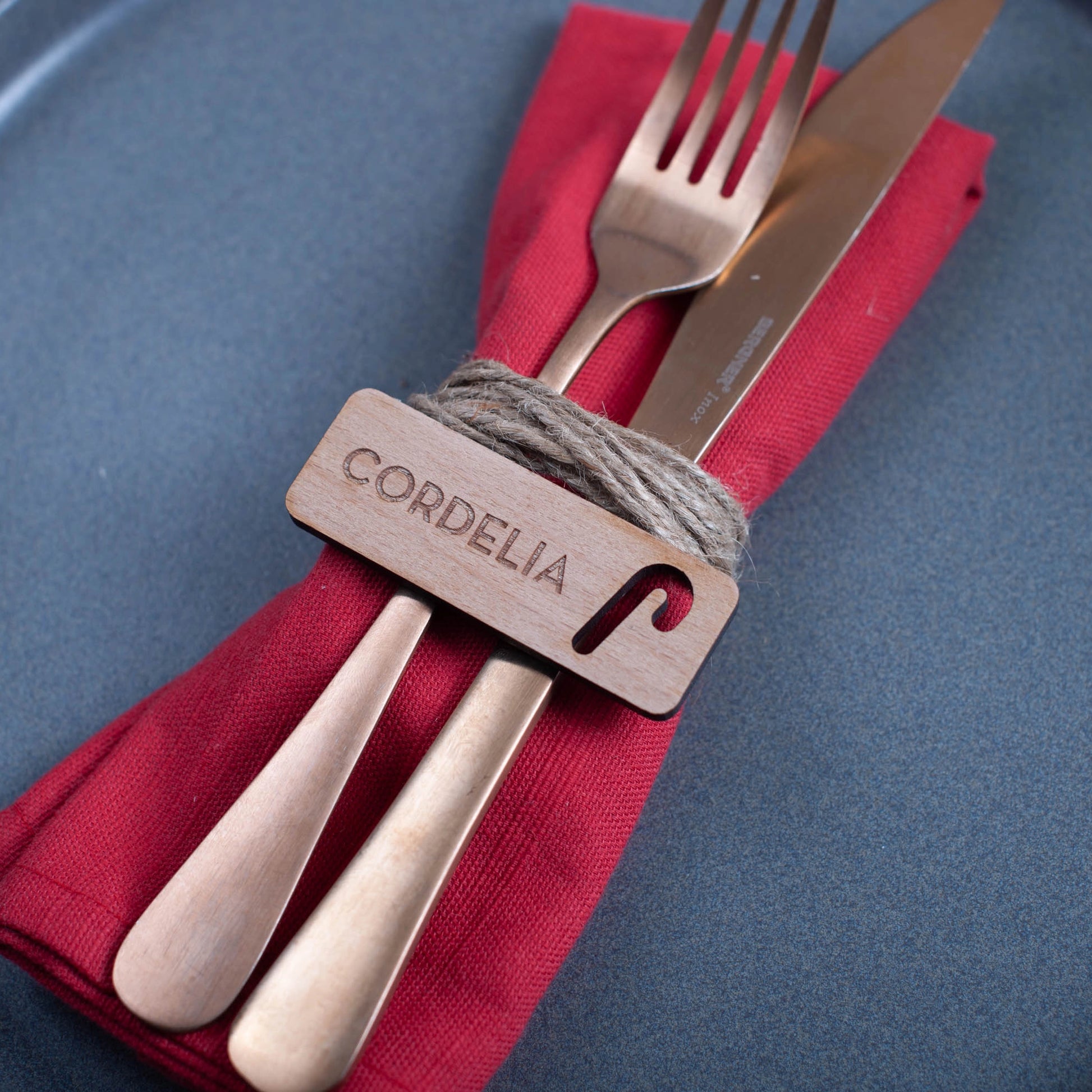 Personalised wooden table setting for Christmas dinner with festive candy cane cutout