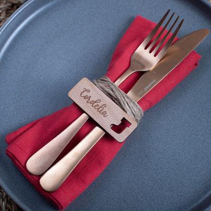 Rectangle wooden name tag with Christmas ornament cutouts on table setting
