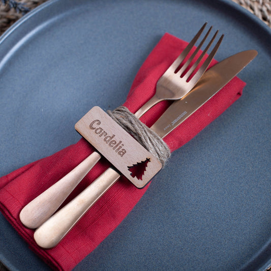 Personalised wooden Christmas place setting with engraved guest name and festive cutouts