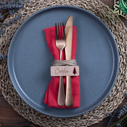 Christmas dinner table flat-lay with engraved wooden place cards and holiday décor