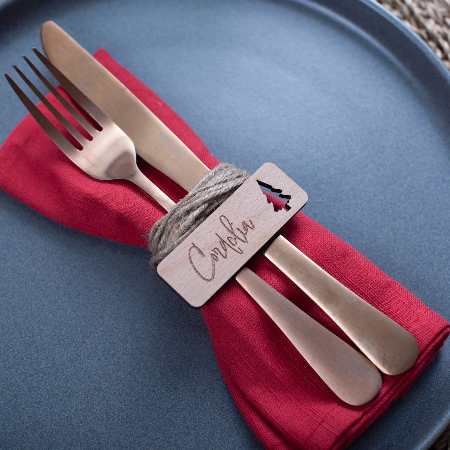 Wooden personalised Christmas name tags styled flat on napkins with christmas tree cutout