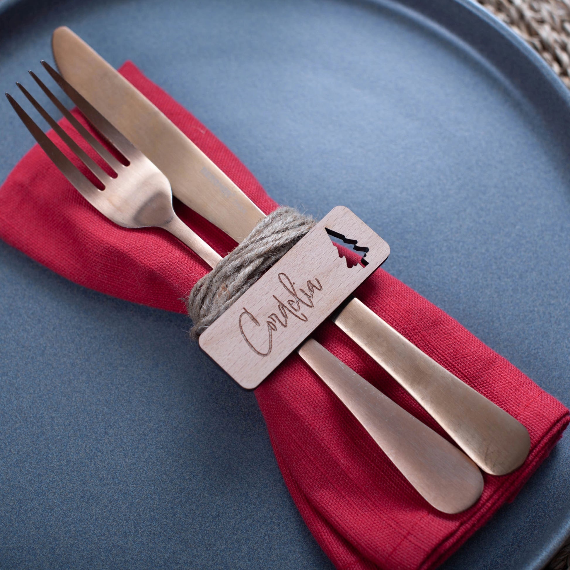 Wooden personalised Christmas name tags styled flat on napkins with christmas tree cutout