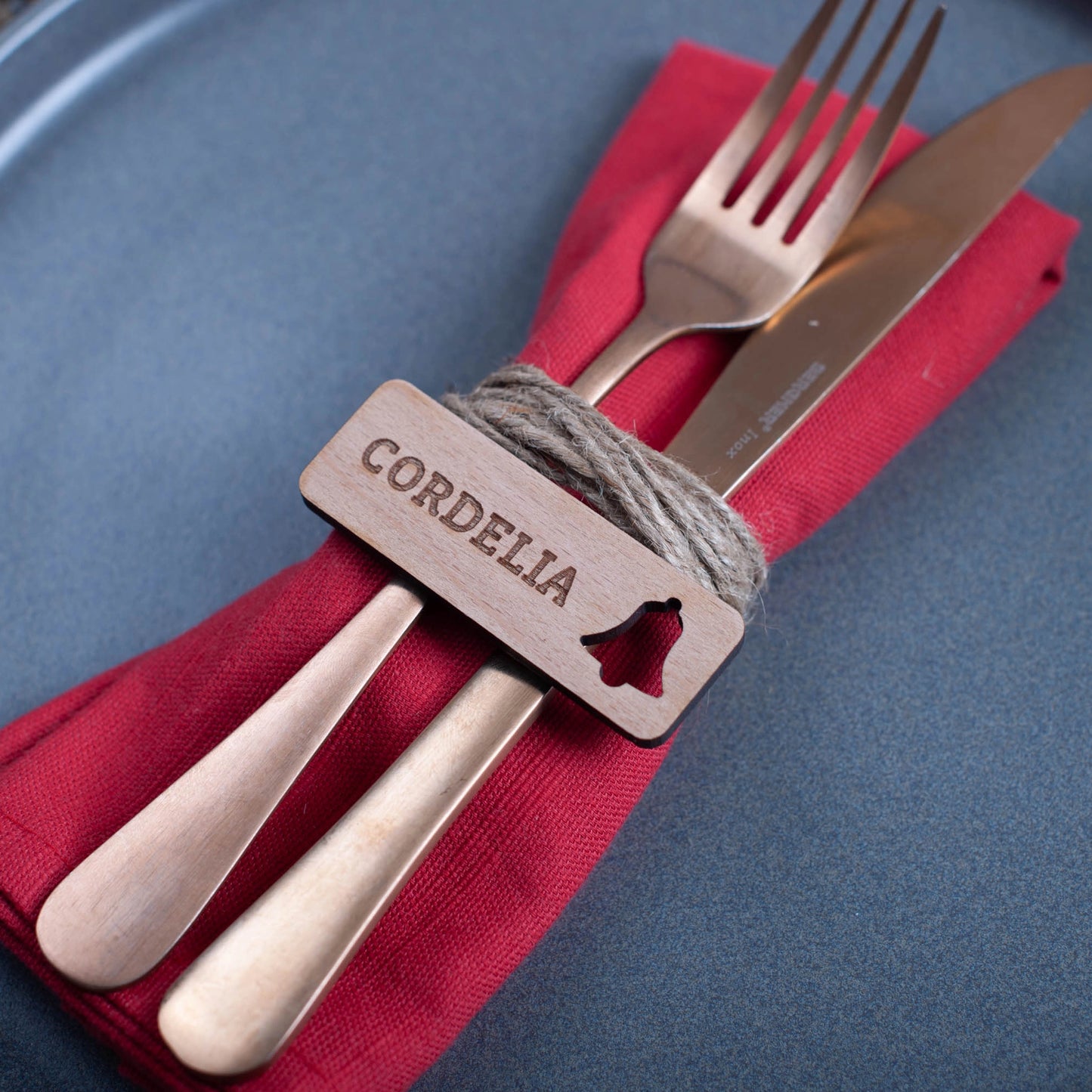 Sustainable wooden Christmas place tag engraved with festive design with bell cutout