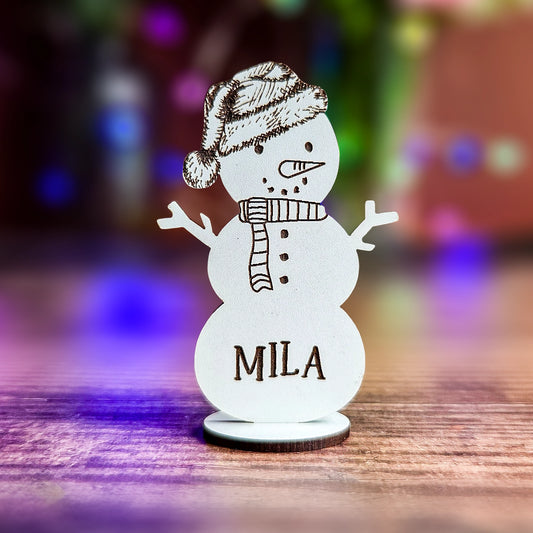 Laser cut snowman name tag in white MDF for festive dinner décor