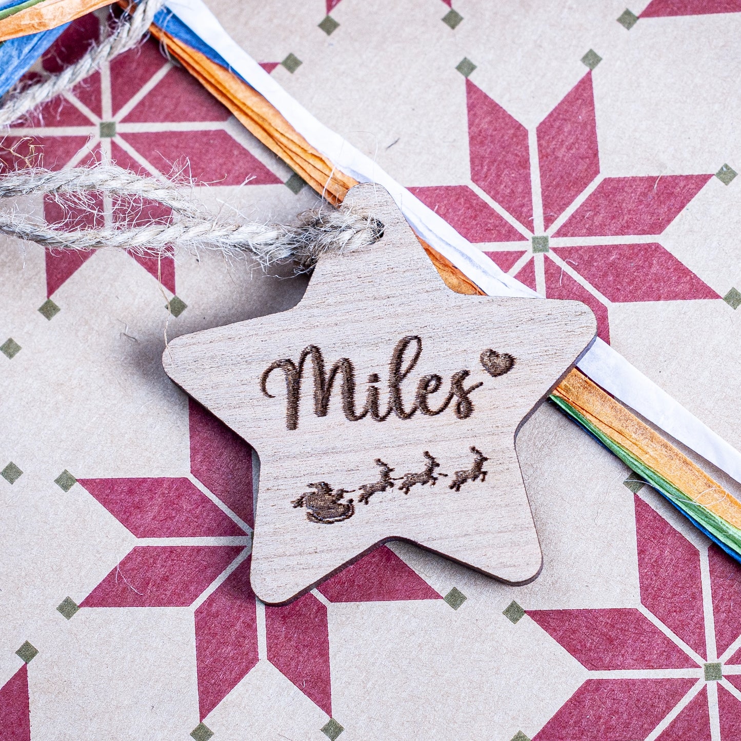 Personalised star-shaped wooden Christmas gift tag laser engraved with name