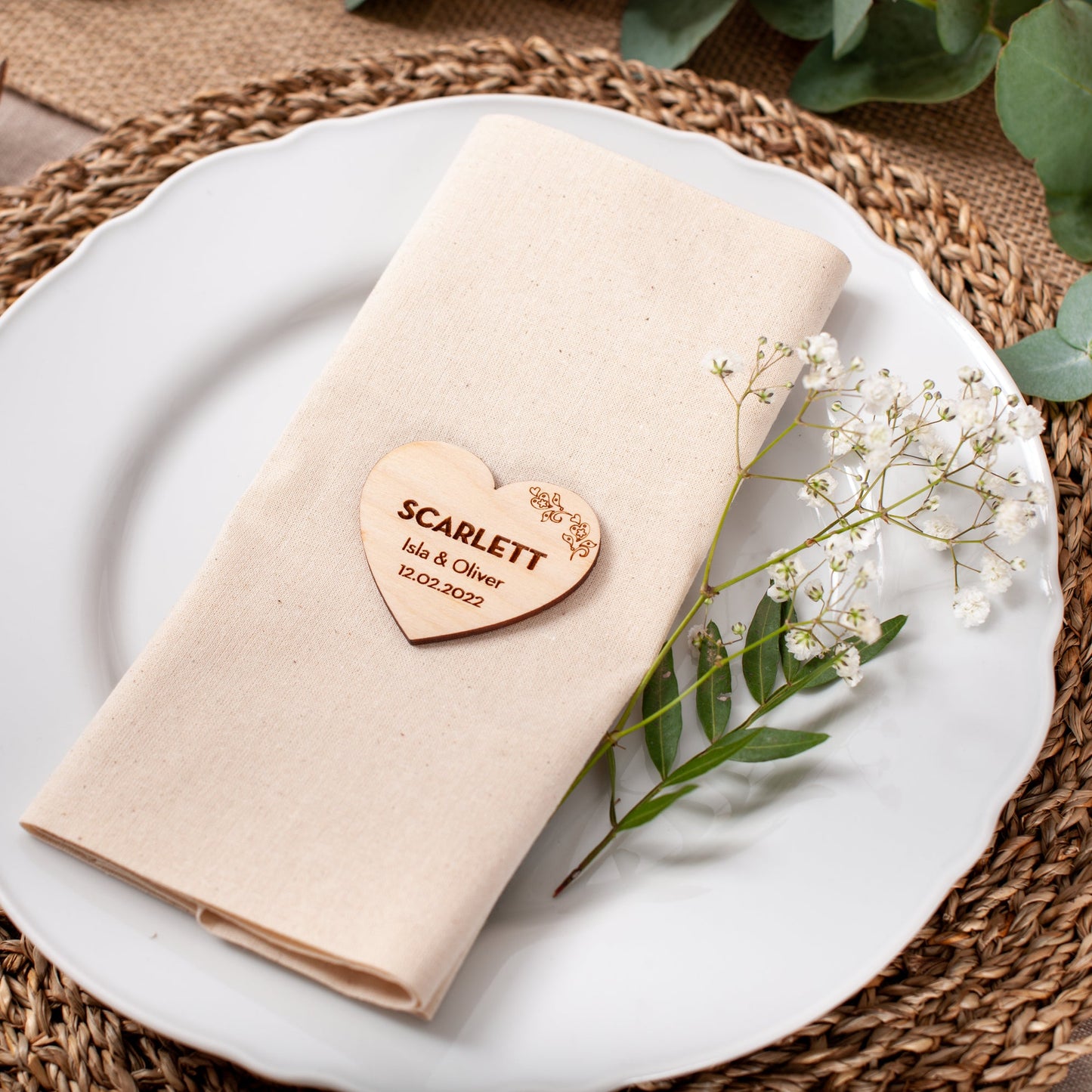 Engraved wood heart place name used as wedding table decor