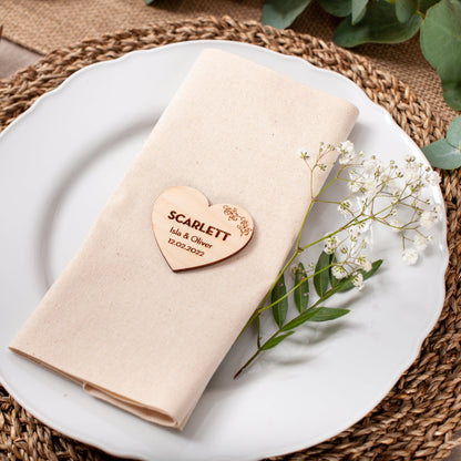 Engraved wood heart place name used as wedding table decor