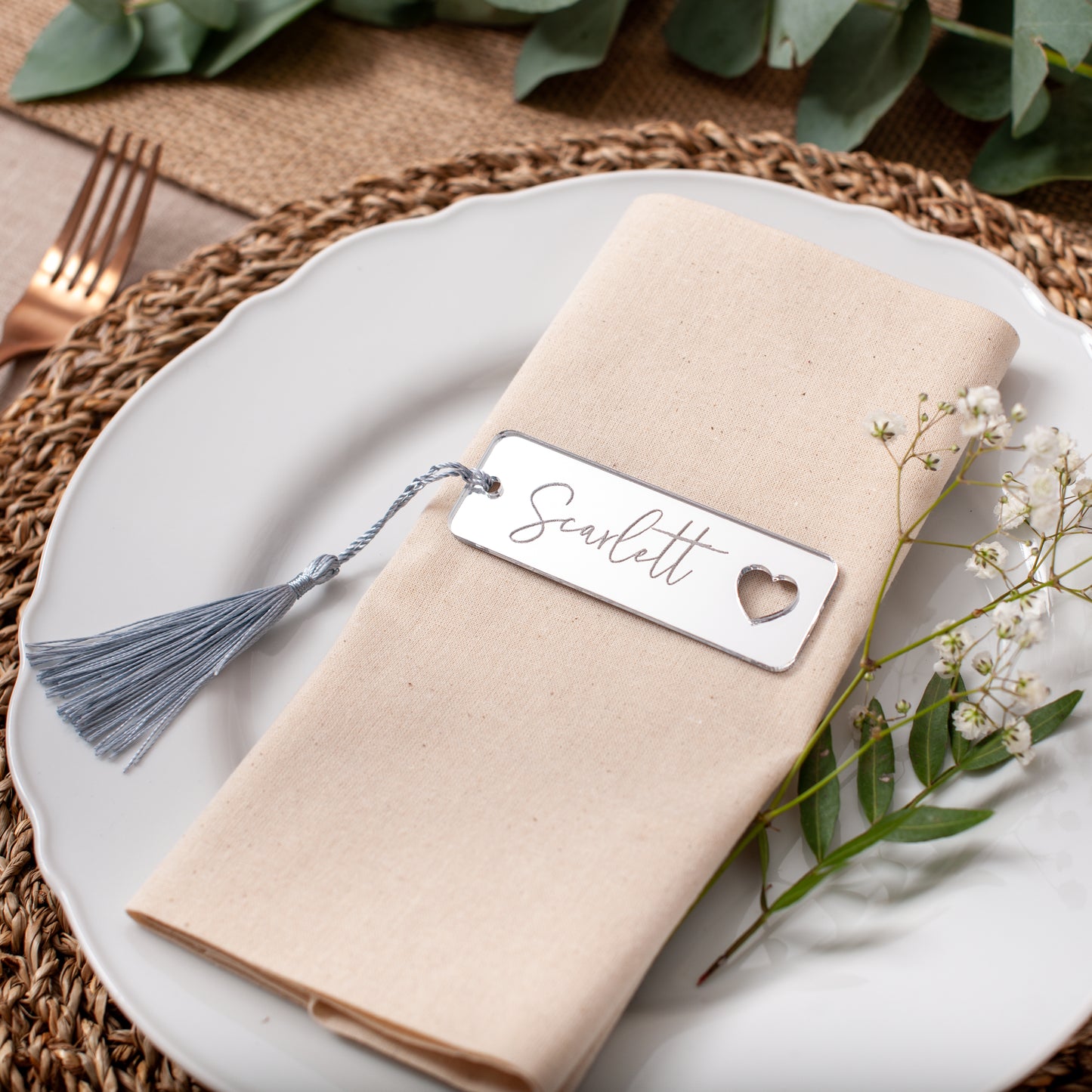 Close-up of personalised mirror acrylic wedding name tags