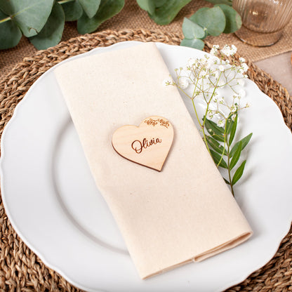 Personalised wooden heart place card with intricate floral detail engraved with guest name